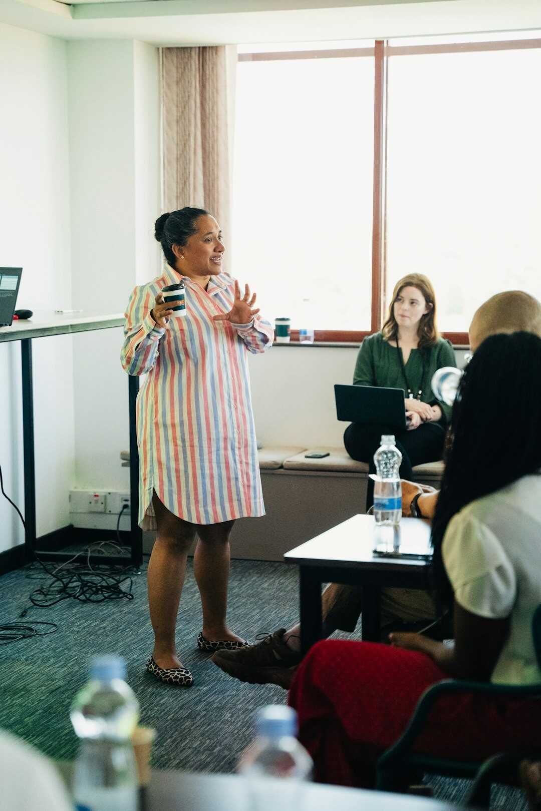 Professional woman confidently speaking at a business conference with microphone